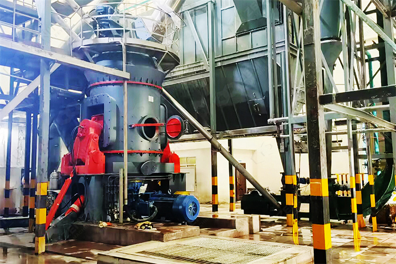 Technician inspecting grinding media in ceramic grinding machine